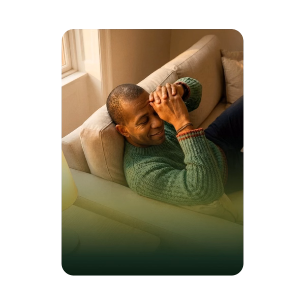 A man relaxing on a sofa with a progress chart
