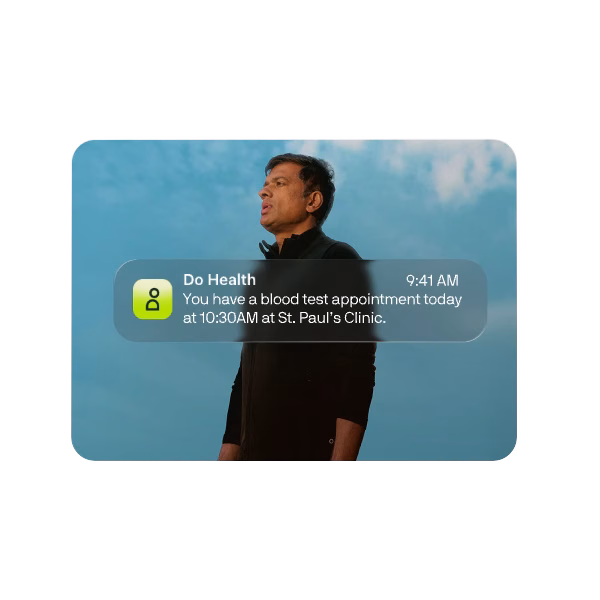 A man against a blue sky with a health appointment notification