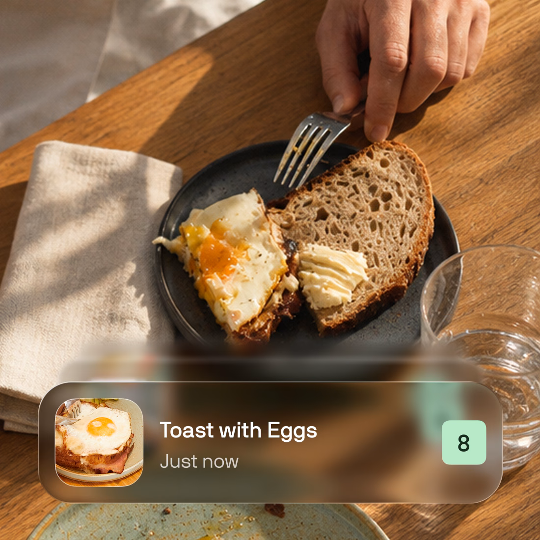 Breakfast on a wooden table with a Toast with Eggs meal-logging card